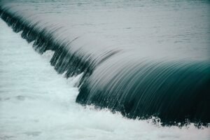 Dynamic image of a cascading waterfall with smooth flowing rapids and serene water motion.